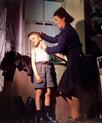 A small boy has his neck washed by his mother Glasgow,  1948
