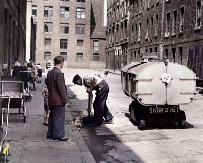 A street cleaner working in Gemmel Street  Bridgeton, 1955.

