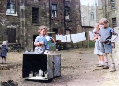 Colourised Photo Children happily playing in the back courts of a Glasgow Tenement 1960s
