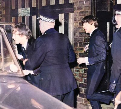 The Beatles  John Lennon and Paul McCartney run to a Car from Stage Door after Show at the Odeon Theatre in Glasgow,  21st October 1964.
