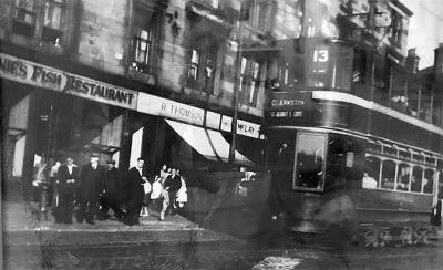 Tram and shoppers on Maryhill Road near Maryhill Central Station
