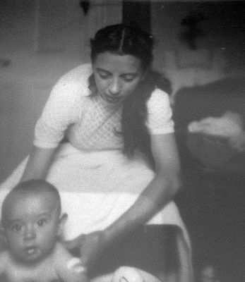 Young woman giving a young boy a tin bath wash, Maryhill Glasgow 1955
