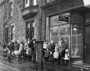 A_queue_of_mothers_and_young_children_waiting_for_the_Post_Office_to_open2C_in_Carmyle_Glasgow_.jpg