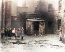 Colourised_Photo_Of_Kids_Posing_For_A_Photograph_In_The_backcourt_At_76_Crown_Street_Gorbals_in_1912.jpg