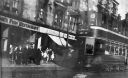 Tram_and_shoppers_on_Maryhill_Road_near_Maryhill_Central_Station.jpg